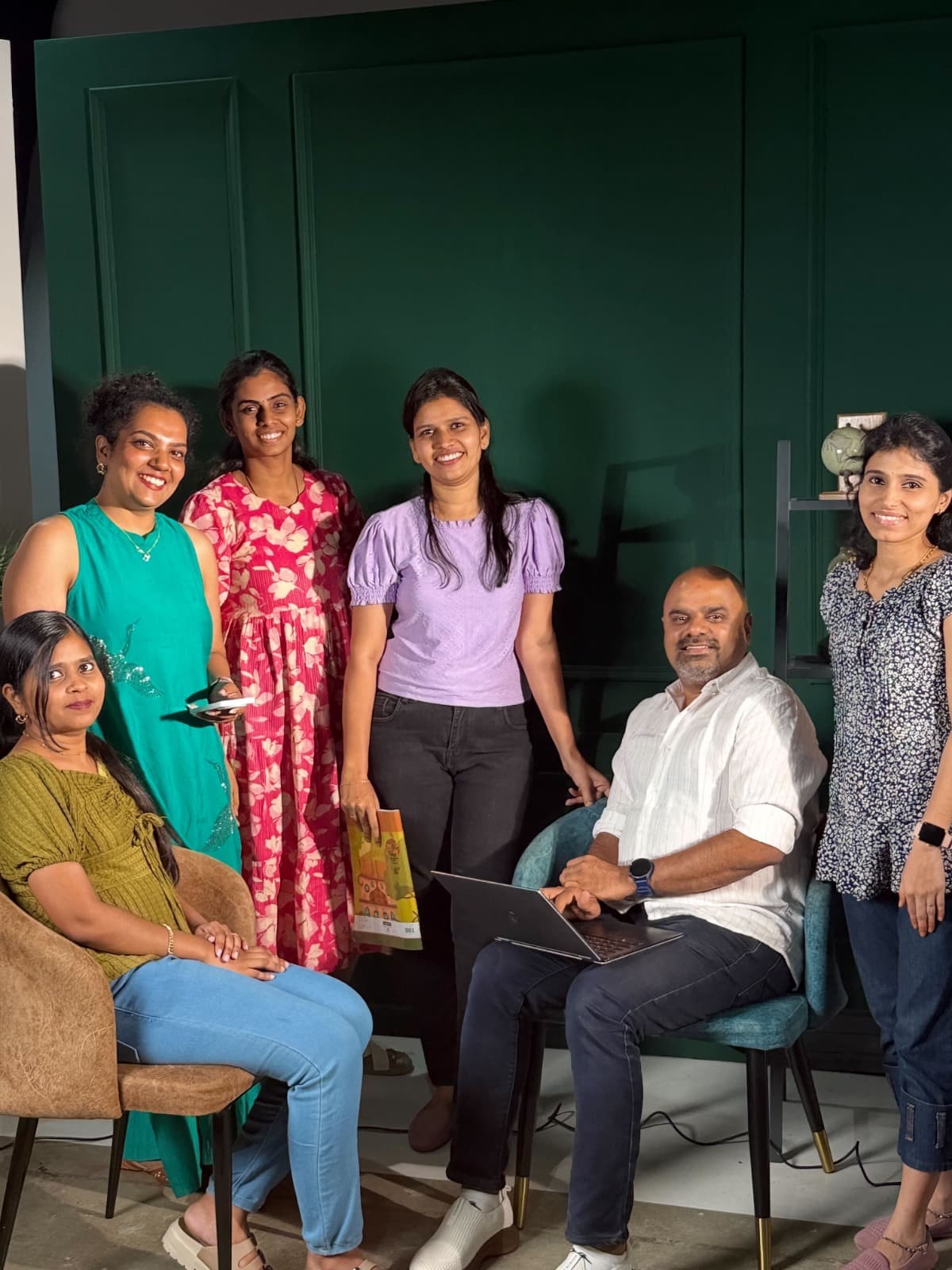 The TheDIco team in a working session with Maran, laptop open